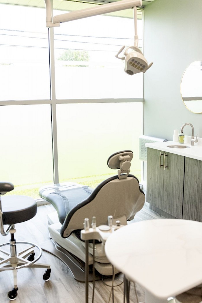 A Soothing Dental treatment room, with the chair beside a full-height frosted window