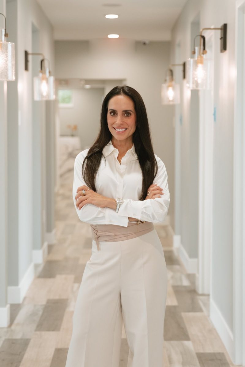 Dr. Alejandra deFuentes Cutter, D.D.S. standing in the treatment corridor at Soothing Dental